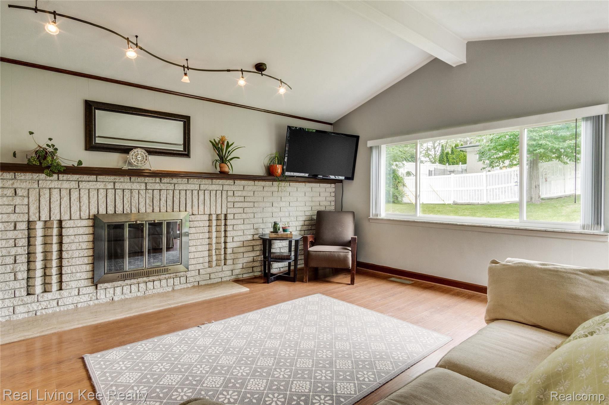 797 Redwood Court Rochester, MI 48309 - Photo 12 of 40 Family room with natural fireplace and large, bright windows