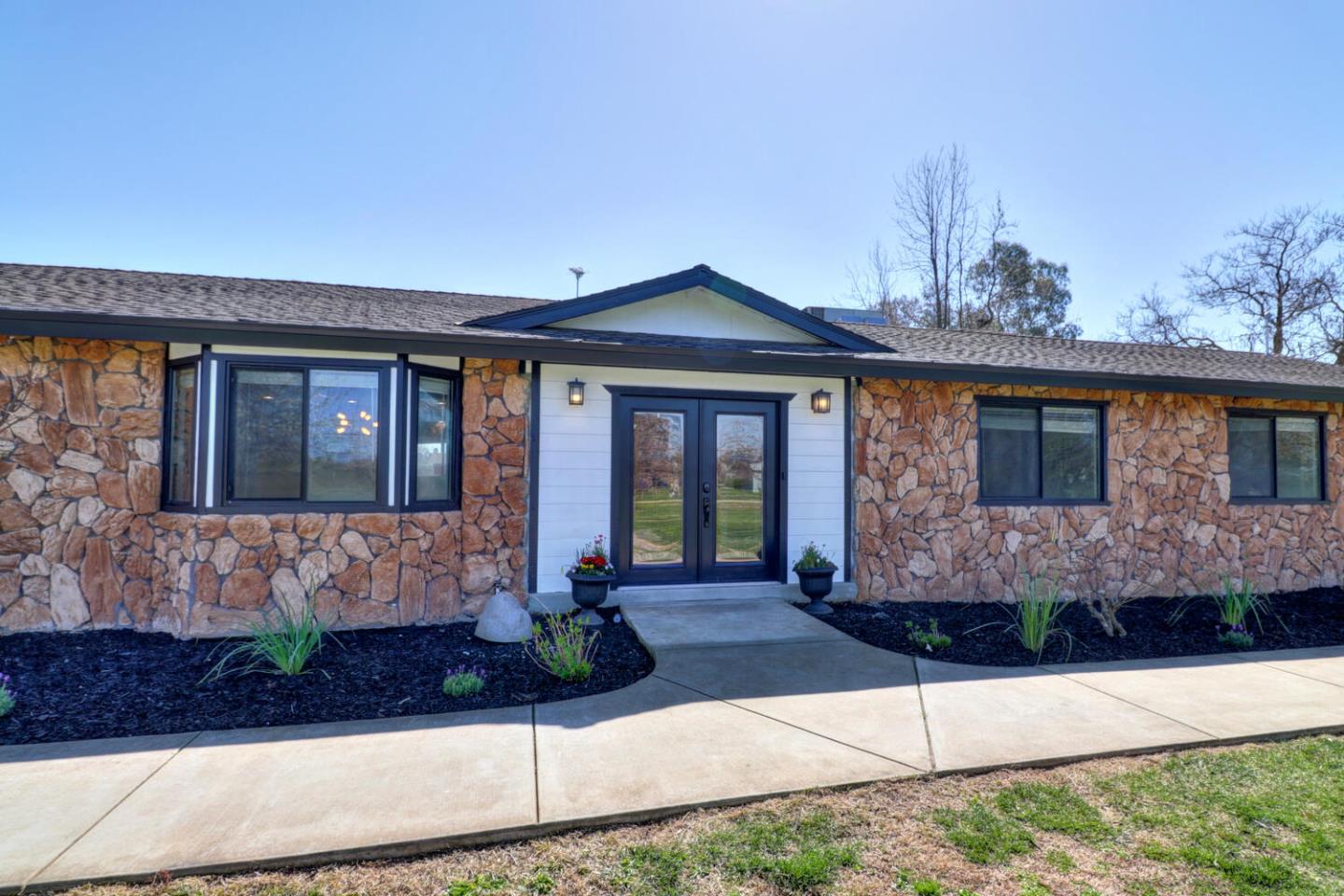 9809 Alta Mesa Road Wilton, CA 95693 - Photo 4 of 86 a front view of a house with garden