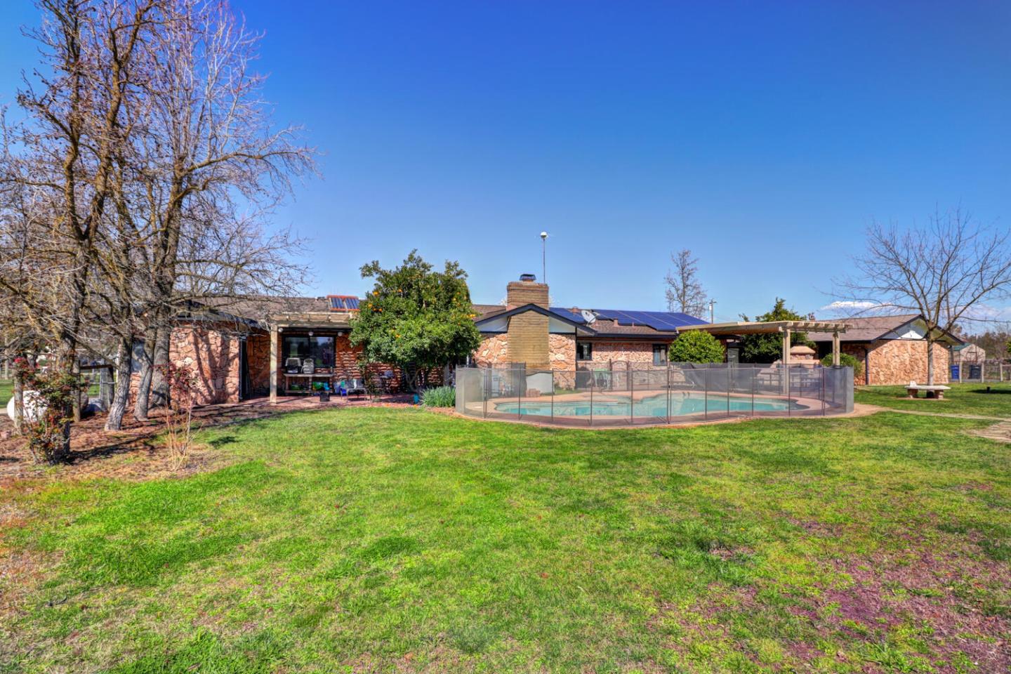 9809 Alta Mesa Road Wilton, CA 95693 - Photo 41 of 86 a white house with a big yard and large trees