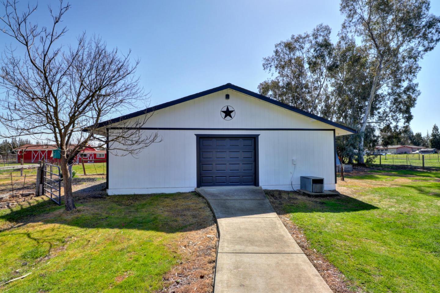 9809 Alta Mesa Road Wilton, CA 95693 - Photo 57 of 86 a front view of house with yard and trees in the background