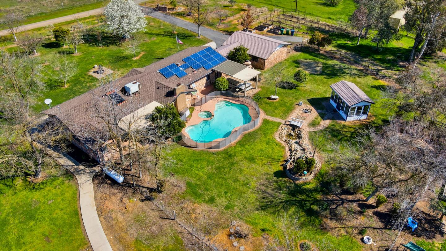 9809 Alta Mesa Road Wilton, CA 95693 - Photo 78 of 86 an aerial view of a house with a yard and lake