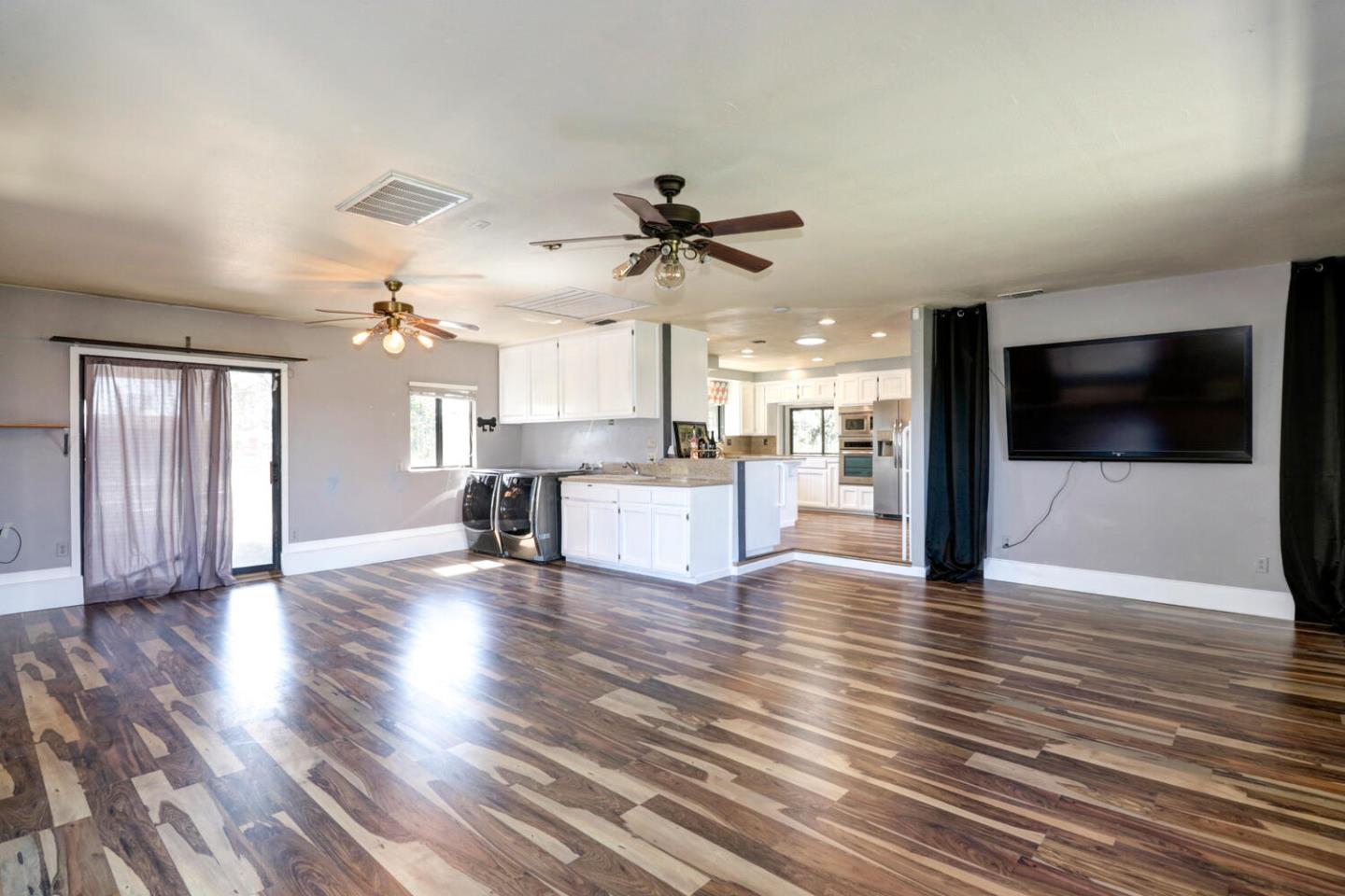 9809 Alta Mesa Road Wilton, CA 95693 - Photo 8 of 86 a view of a kitchen with a flat screen tv wooden floor and a kitchen