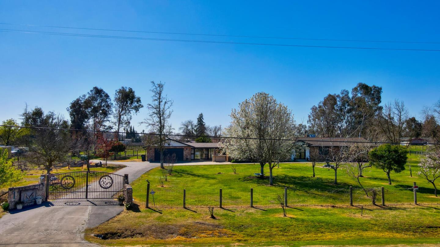 9809 Alta Mesa Road Wilton, CA 95693 - Photo 85 of 86 a view of a swimming pool with a garden and trees