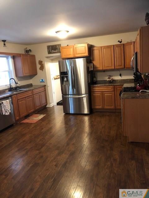 44 Pleasant Valley Road Old Bridge, NJ 08857 - Photo 5 of 14 a kitchen with granite countertop a refrigerator stove and wooden floor