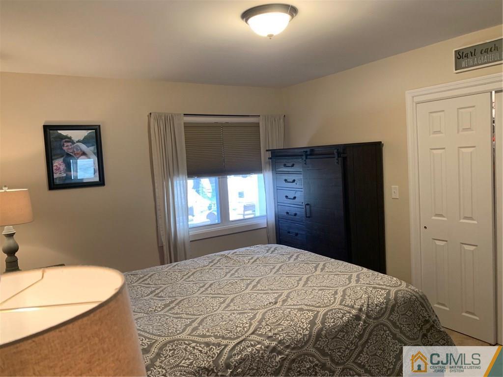 44 Pleasant Valley Road Old Bridge, NJ 08857 - Photo 7 of 14 a bedroom with a bed and a chandelier