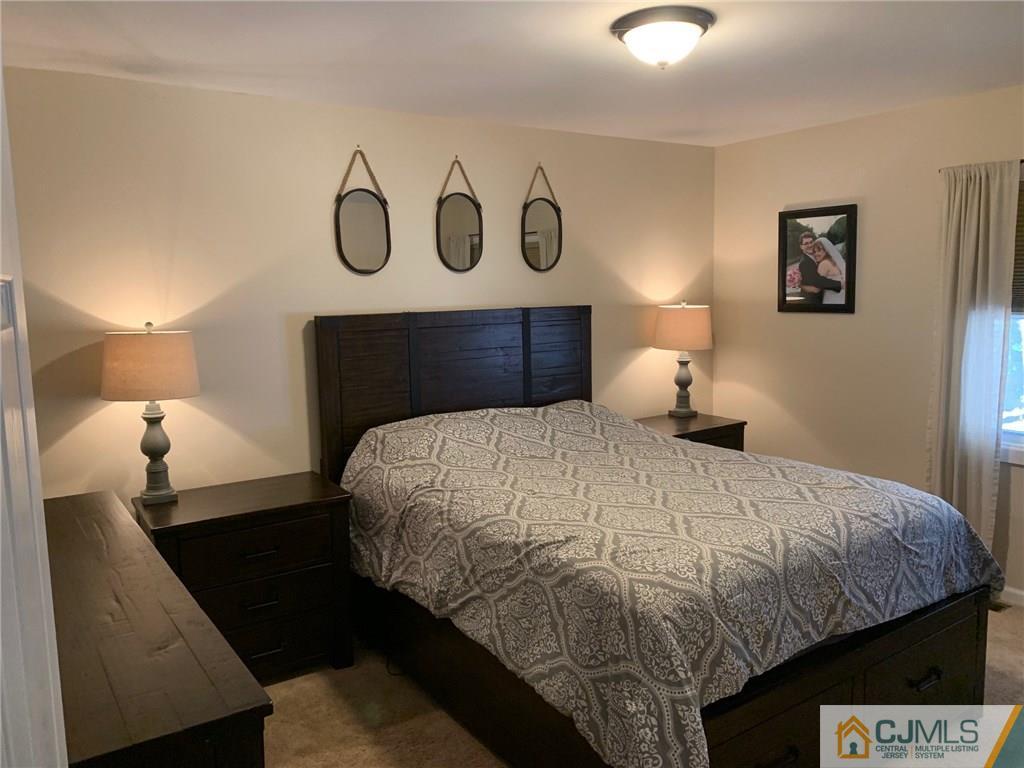 44 Pleasant Valley Road Old Bridge, NJ 08857 - Photo 8 of 14 a bedroom with a bed and lamp