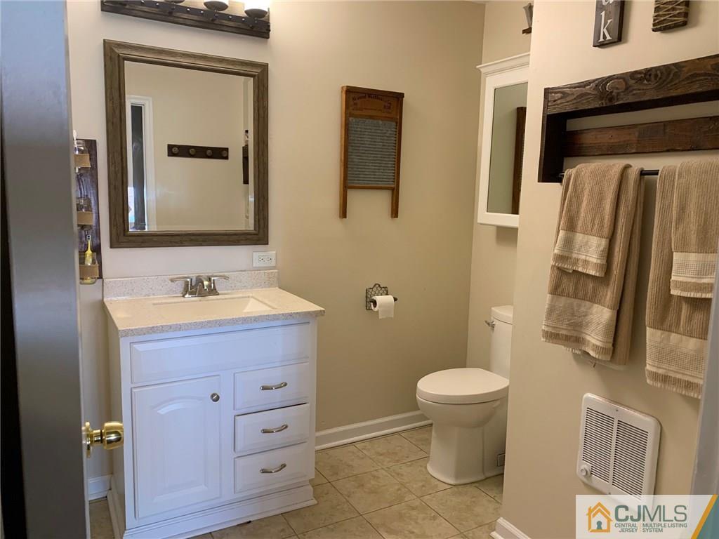 44 Pleasant Valley Road Old Bridge, NJ 08857 - Photo 10 of 14 a bathroom with a toilet sink and mirror