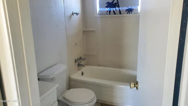 a bathroom with a bathtub and toilet