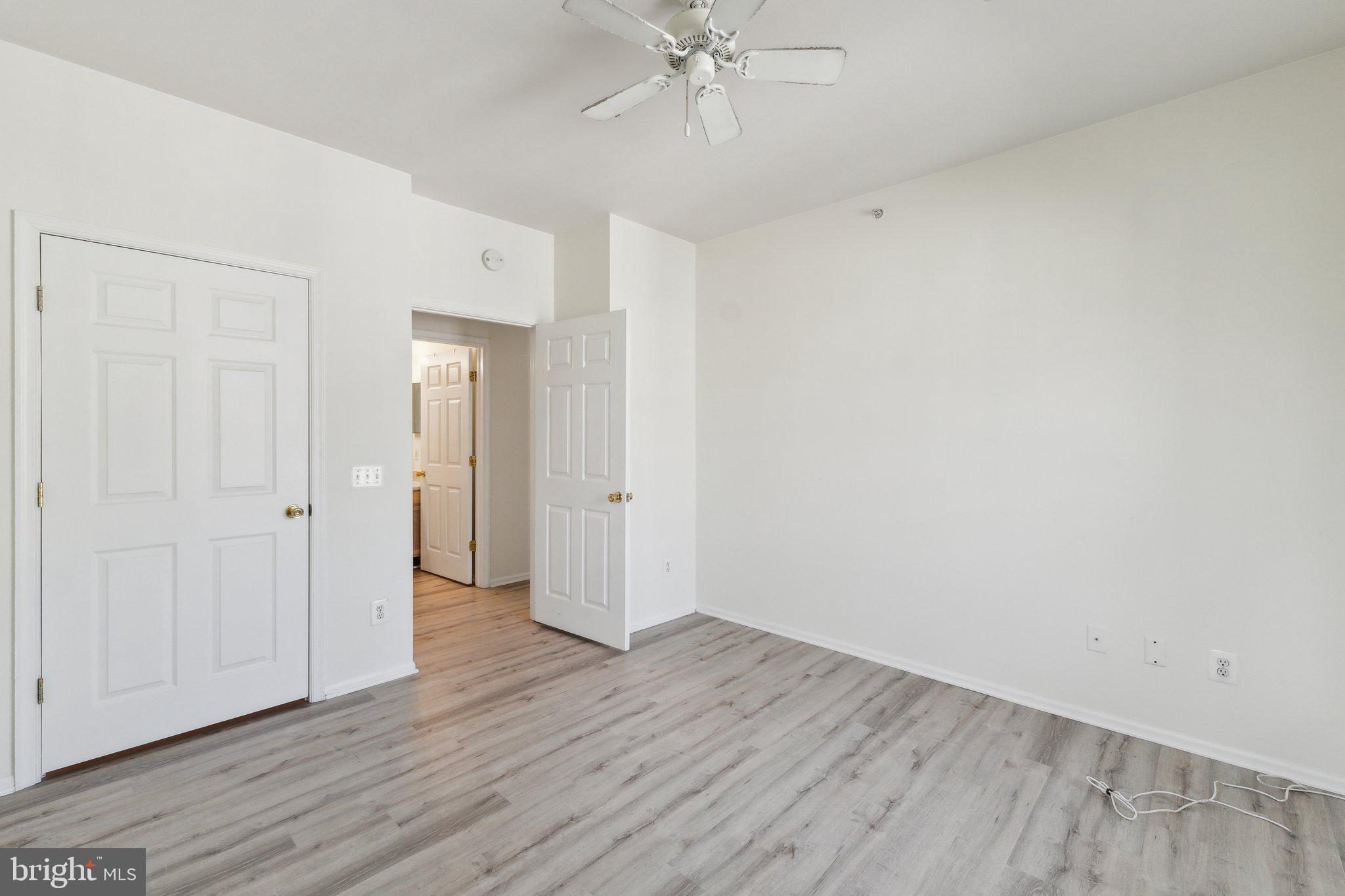 1591 Spring Gate Dr., Unit 3415 McLean, VA 22102 - Photo 11 of 20 a view of an empty room with wooden floor