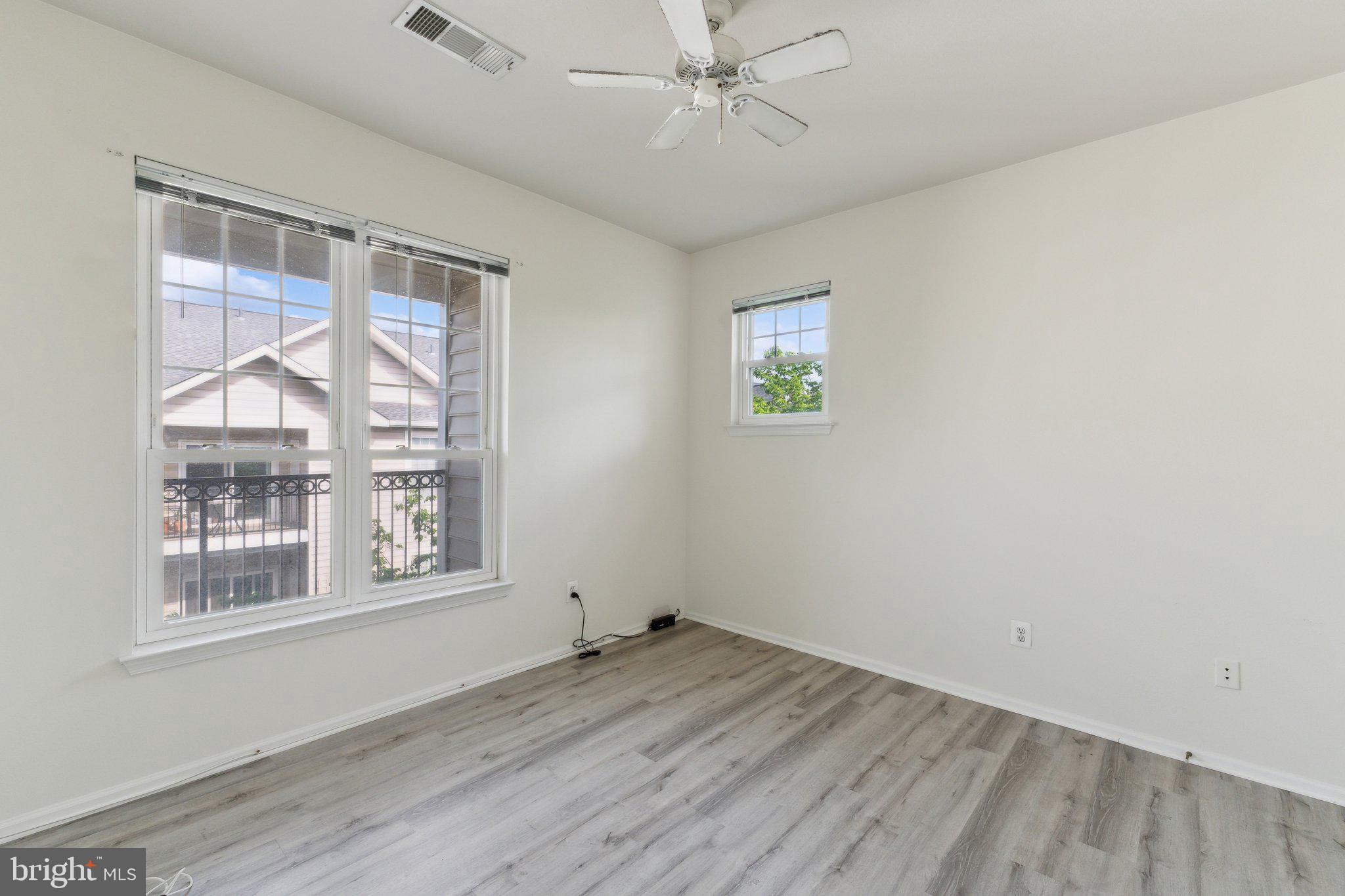 1591 Spring Gate Dr., Unit 3415 McLean, VA 22102 - Photo 13 of 20 an empty room with a window and ceiling fan