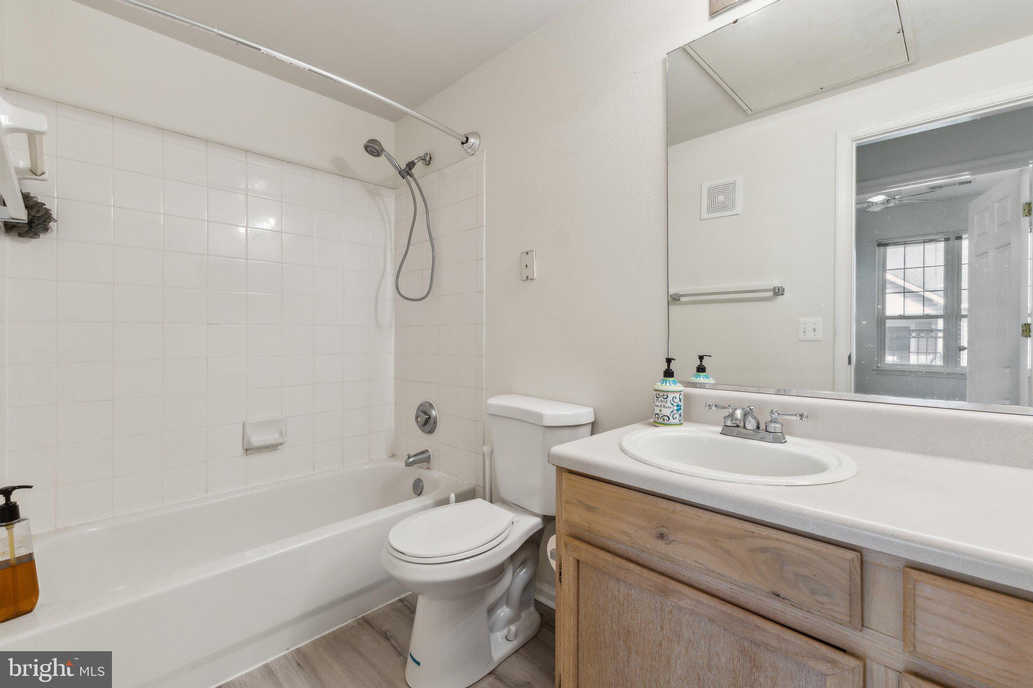 1591 Spring Gate Dr., Unit 3415 McLean, VA 22102 - Photo 16 of 20 a bathroom with a sink a toilet and shower