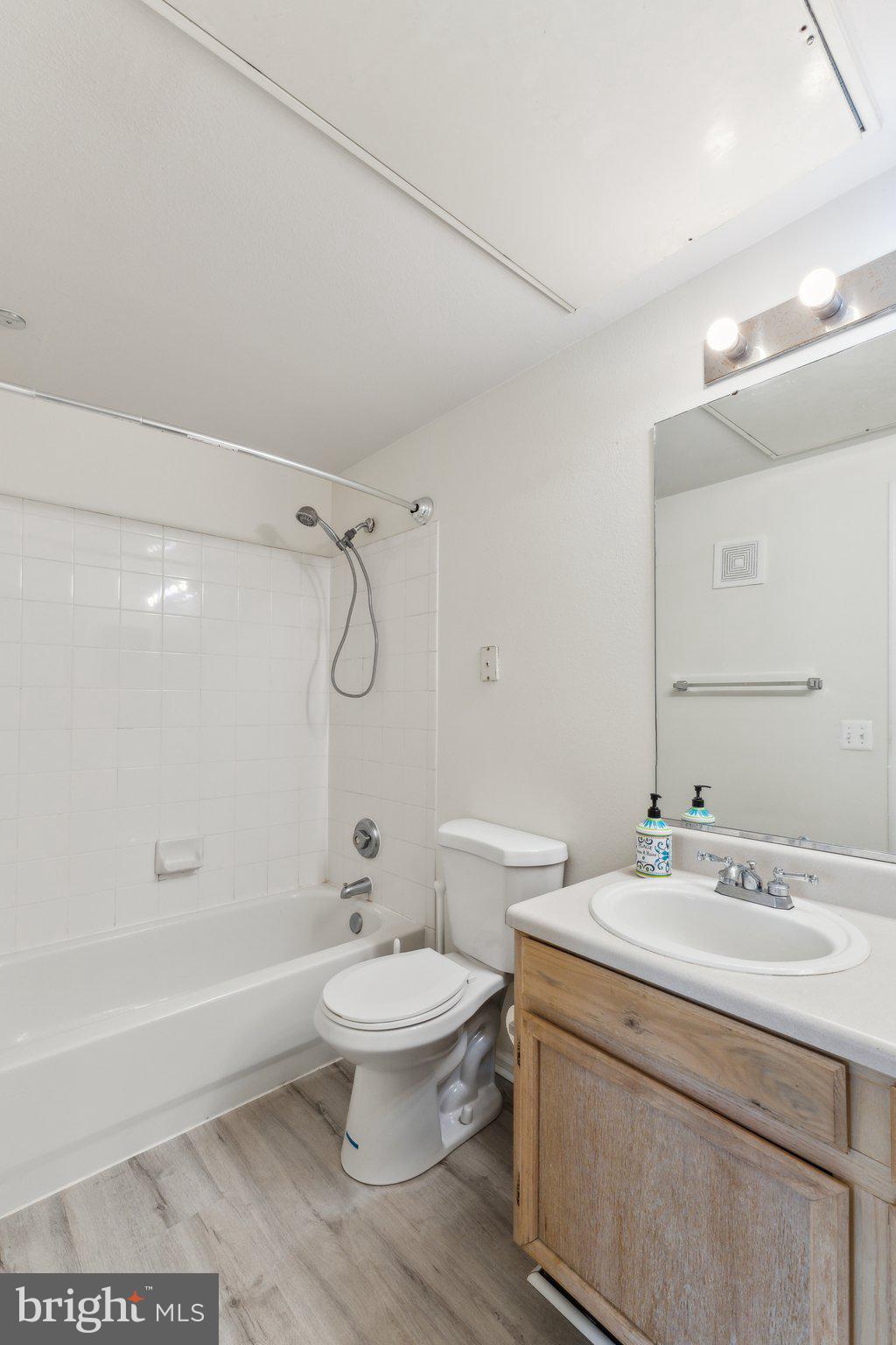 1591 Spring Gate Dr., Unit 3415 McLean, VA 22102 - Photo 17 of 20 a bathroom with a sink a toilet and shower