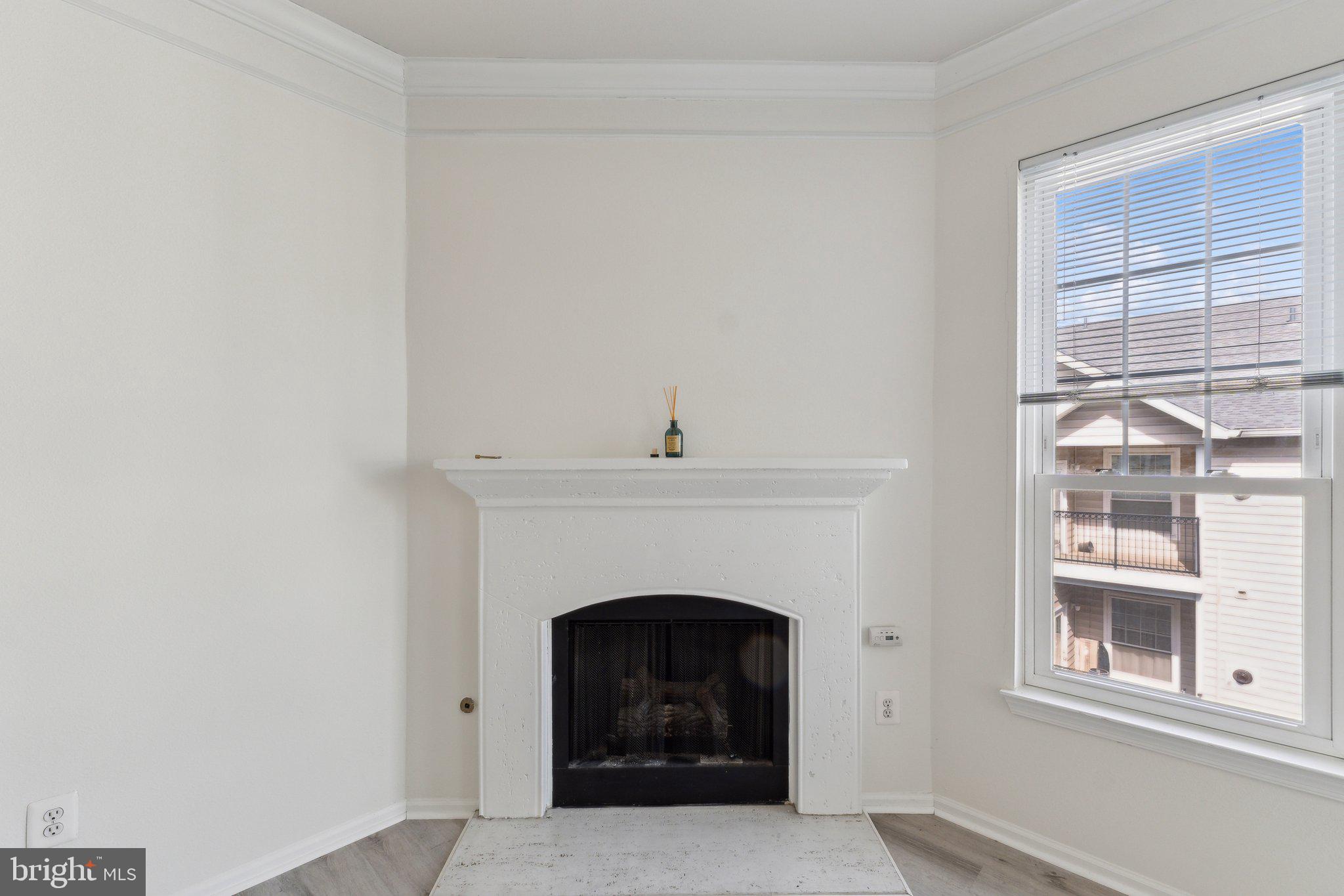 1591 Spring Gate Dr., Unit 3415 McLean, VA 22102 - Photo 5 of 20 a living room with a fireplace and a window