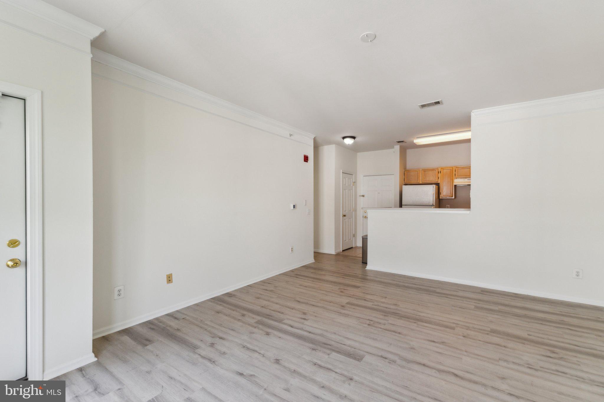 1591 Spring Gate Dr., Unit 3415 McLean, VA 22102 - Photo 6 of 20 a view of a room with wooden floor