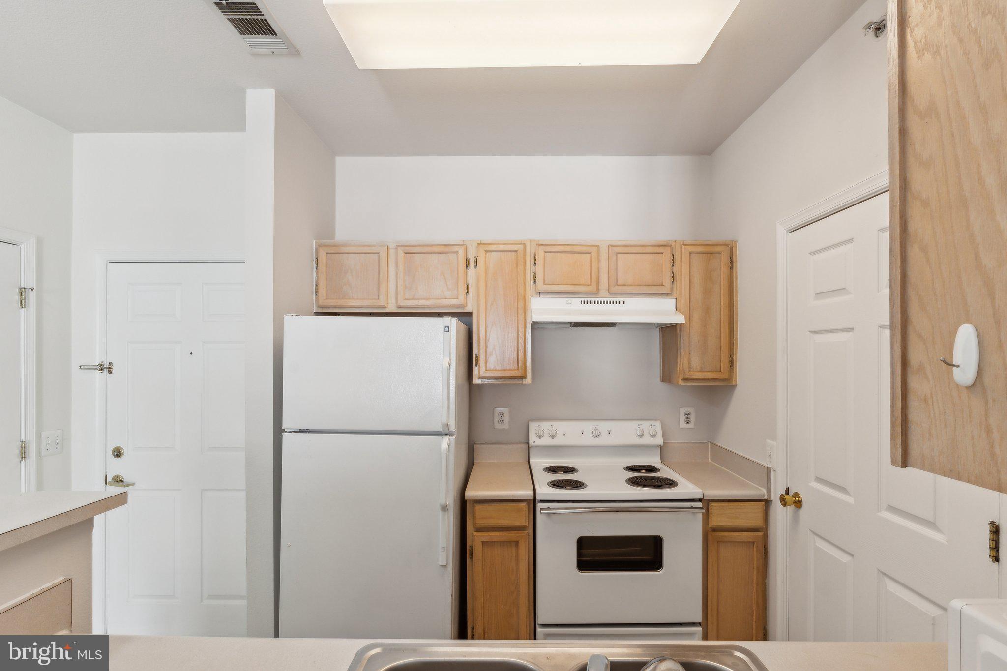 1591 Spring Gate Dr., Unit 3415 McLean, VA 22102 - Photo 8 of 20 a kitchen with a stove top oven and refrigerator