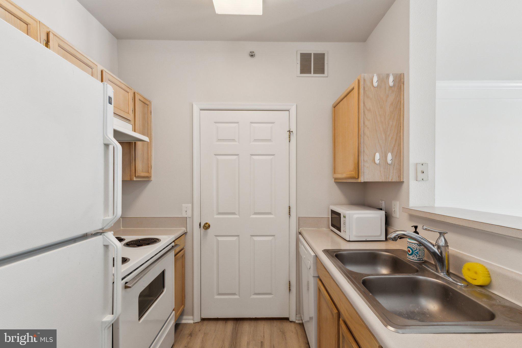1591 Spring Gate Dr., Unit 3415 McLean, VA 22102 - Photo 9 of 20 a kitchen that has a sink and a stove