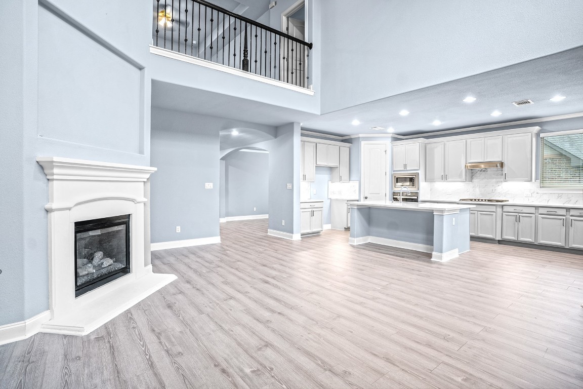 2328 Blended Tree Ranch Drive Leander, TX 78641 - Photo 11 of 30 a view of kitchen with kitchen island wooden floor and stainless steel appliances