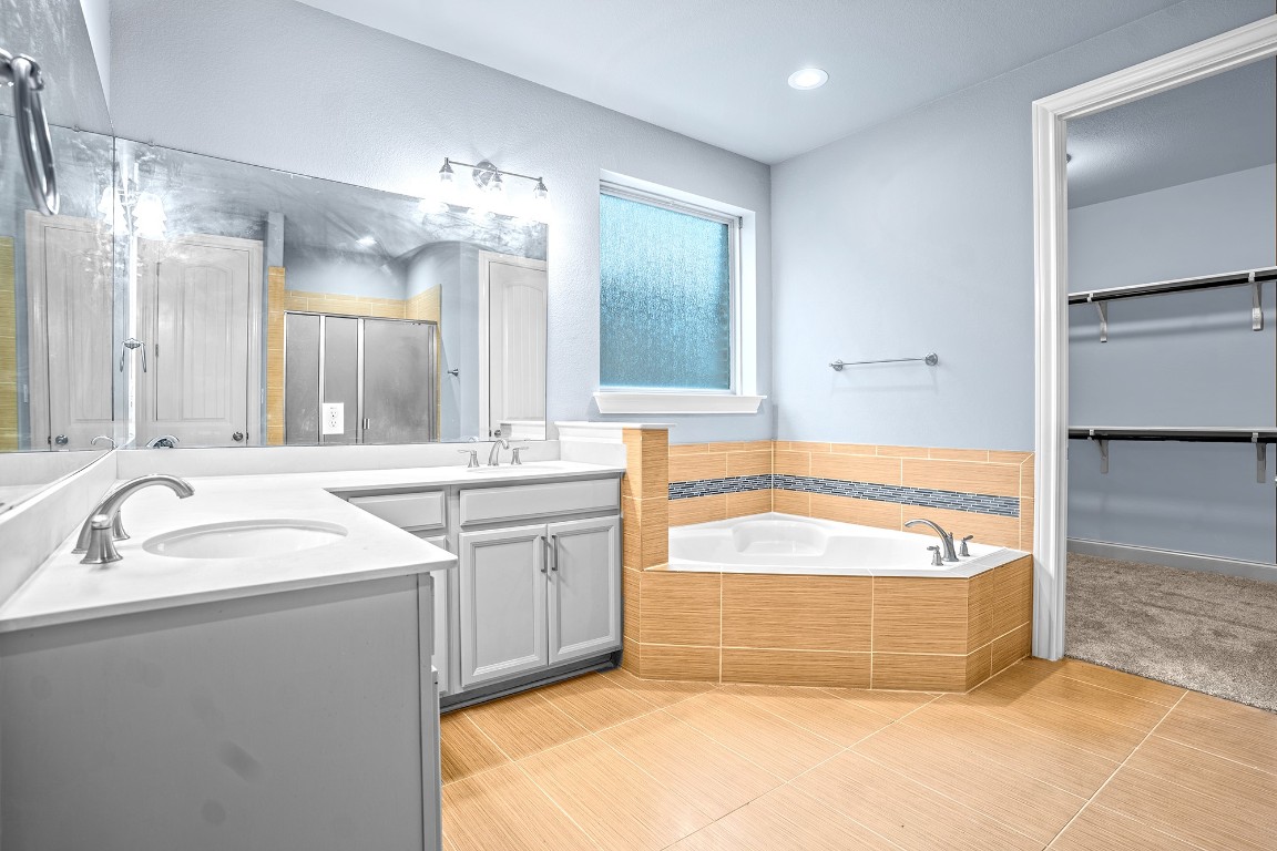 2328 Blended Tree Ranch Drive Leander, TX 78641 - Photo 15 of 30 a spacious bathroom with a tub sink and mirror