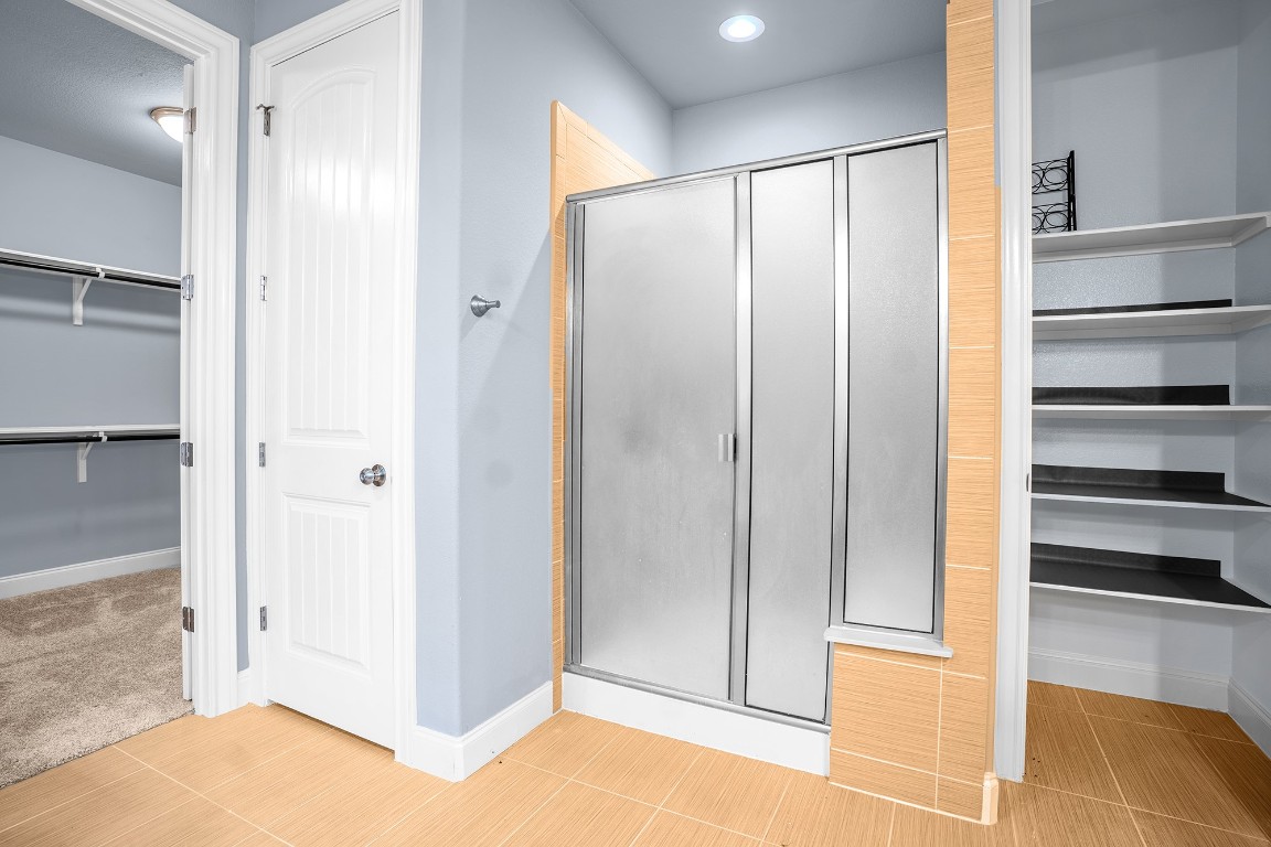 2328 Blended Tree Ranch Drive Leander, TX 78641 - Photo 17 of 30 a bathroom with a glass shower door and a sink