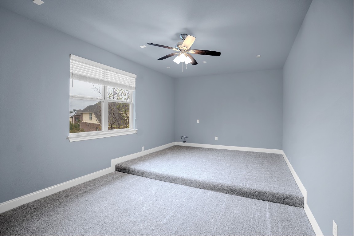 2328 Blended Tree Ranch Drive Leander, TX 78641 - Photo 21 of 30 an empty room with windows and fan