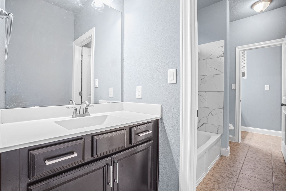 2328 Blended Tree Ranch Drive Leander, TX 78641 - Photo 24 of 30 a bathroom with a sink and a bathtub