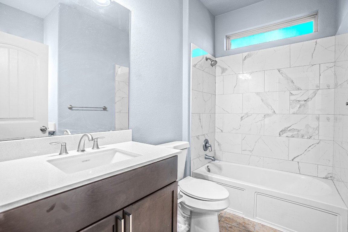 2328 Blended Tree Ranch Drive Leander, TX 78641 - Photo 27 of 30 a bathroom with a sink a toilet a shower curtain and a bath tub