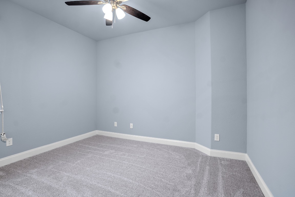 2328 Blended Tree Ranch Drive Leander, TX 78641 - Photo 28 of 30 a view of an empty room with a chandelier fan