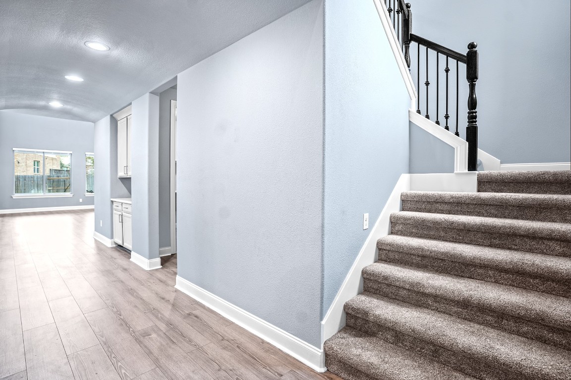 2328 Blended Tree Ranch Drive Leander, TX 78641 - Photo 6 of 30 a view of an entryway with wooden floor and stairs