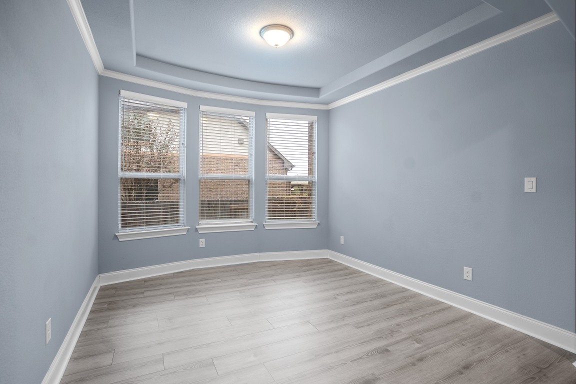 2328 Blended Tree Ranch Drive Leander, TX 78641 - Photo 8 of 30 a view of an empty room with wooden floor and a window