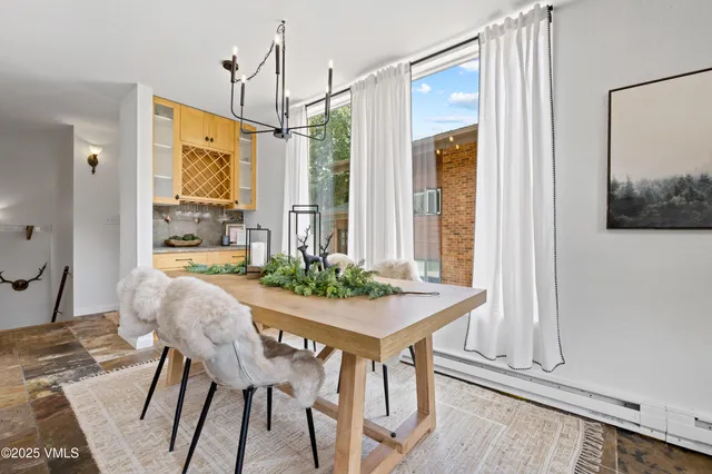 a dining room with furniture and window