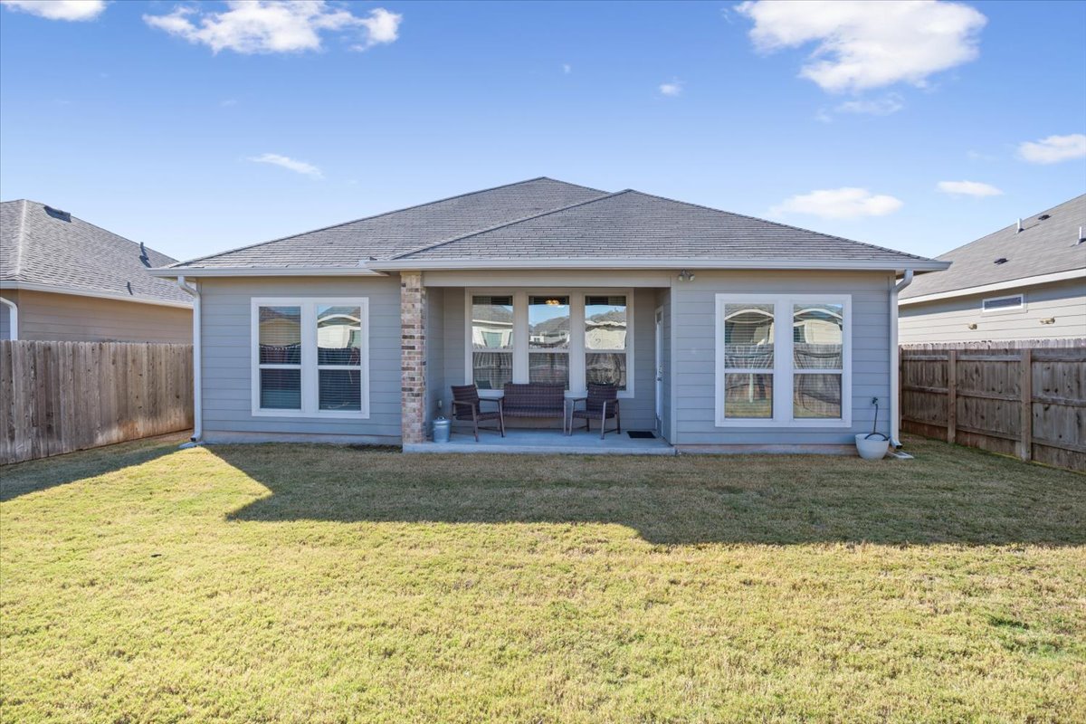 1149 Spring Terrace Loop Temple, TX 76502 - Photo 23 of 25 Fully fenced backyard offering plenty of space for pets or outdoor activities, complete with a covered patio for year-round enjoyment.