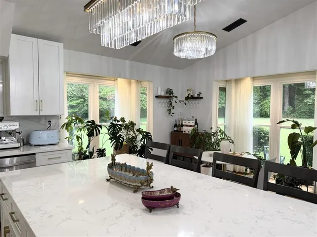 a room with gym equipment and large windows