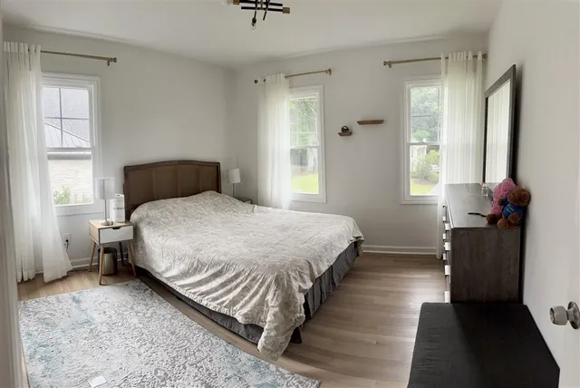 a bedroom with a bed and window