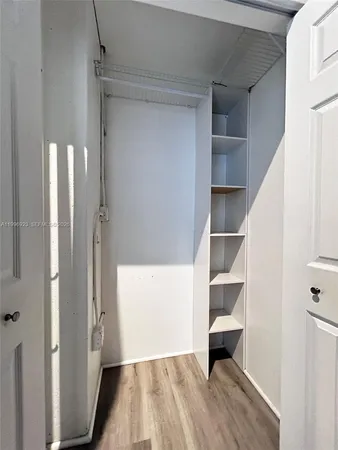 a view of walk in closet with empty racks