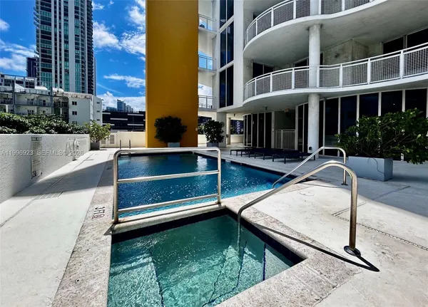 a view of building with swimming pool and sitting space
