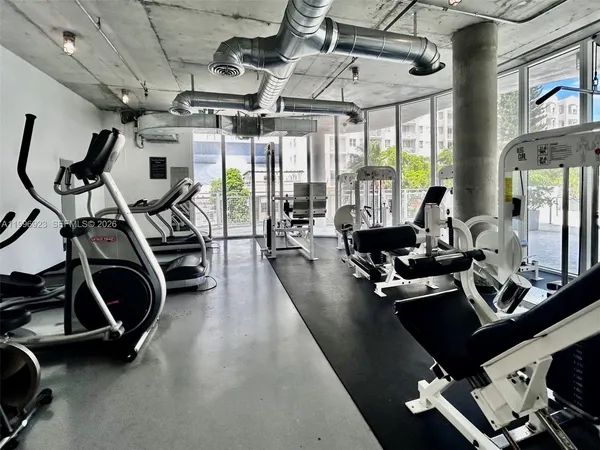 a room with gym equipment and a large window