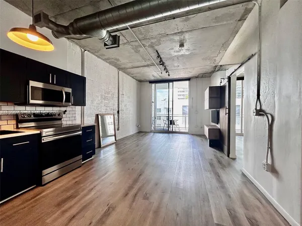 a kitchen with stainless steel appliances a stove refrigerator and microwave