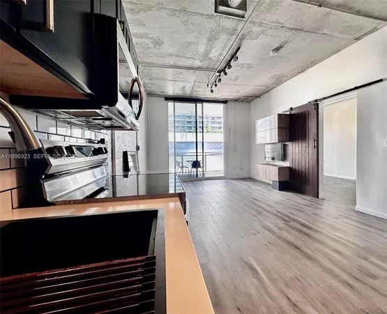 a view of a living room with wooden floor
