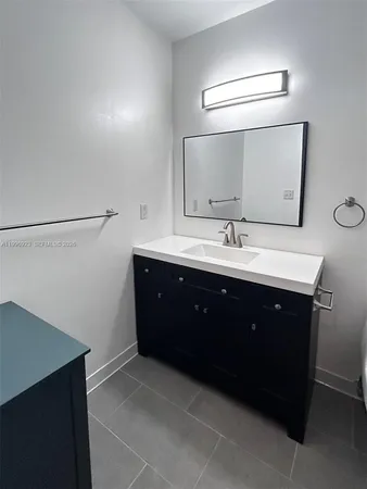 a bathroom with a sink vanity and mirror