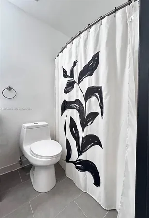 a bathroom with a toilet and a mirror