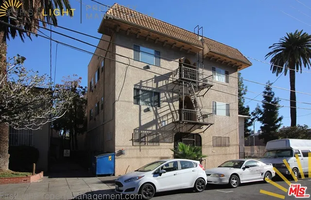 a view of cars parked in front of a house