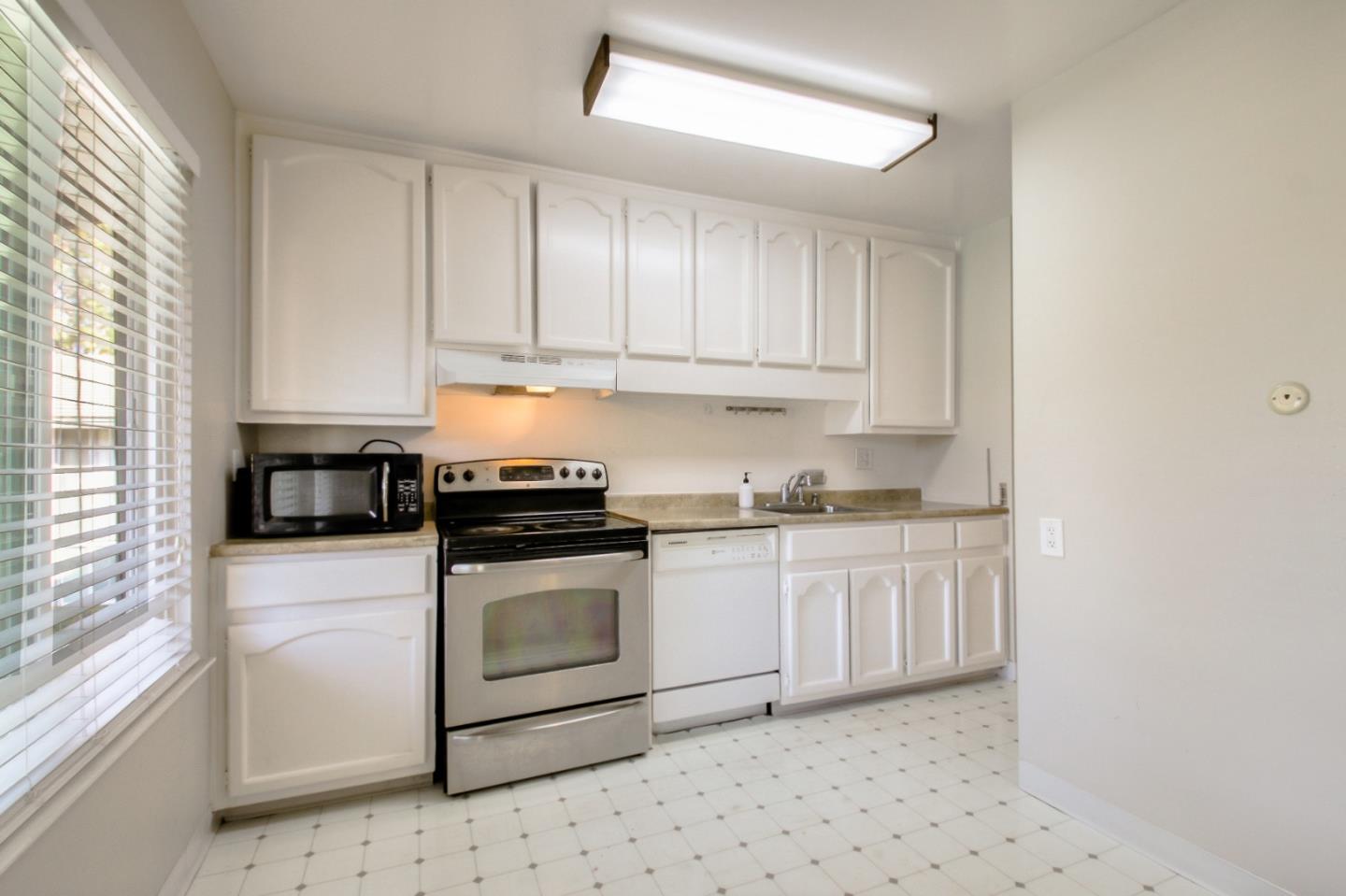 4888 Clayton Road, Unit 31 Concord, CA 94521 - Photo 8 of 23 a kitchen with granite countertop white cabinets and white appliances