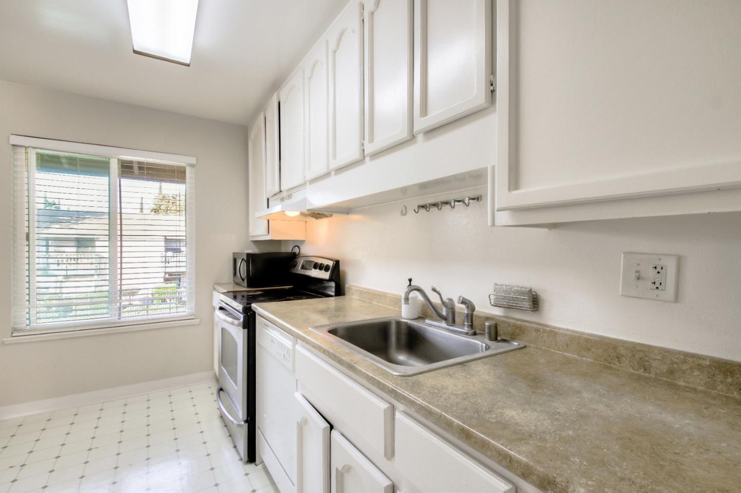 4888 Clayton Road, Unit 31 Concord, CA 94521 - Photo 9 of 23 a kitchen that has a sink and a stove