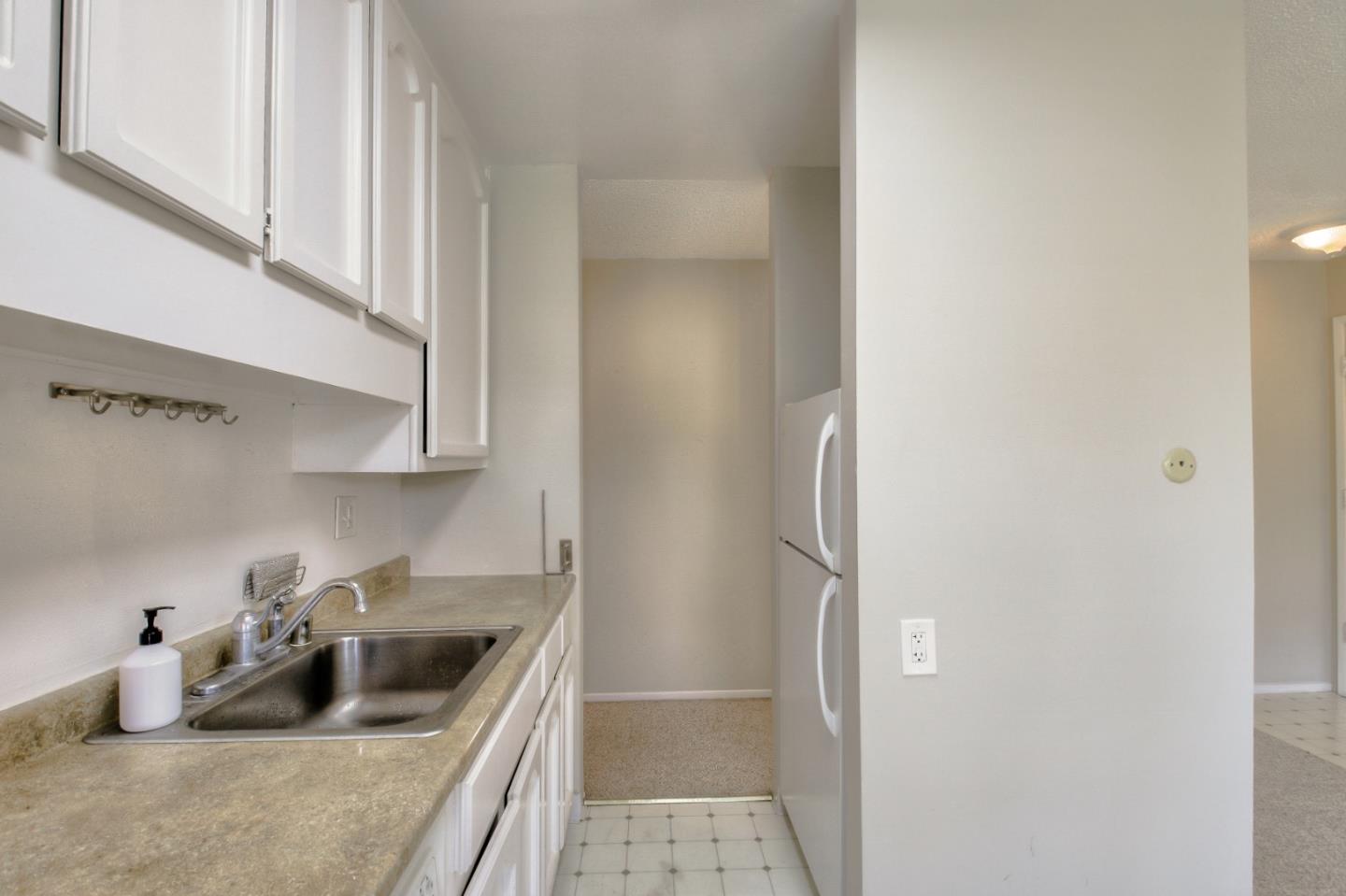 4888 Clayton Road, Unit 31 Concord, CA 94521 - Photo 10 of 23 a kitchen with a refrigerator sink and cabinets