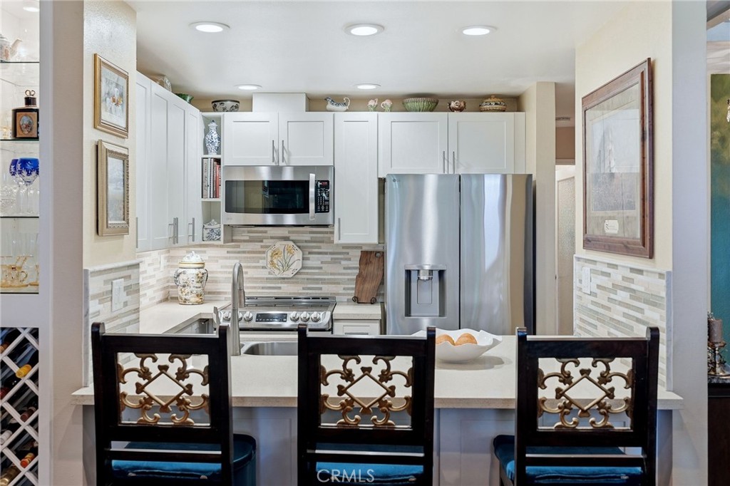 7890 East Spring Street, Unit 2L Long Beach, CA 90815 - Photo 15 of 47 a kitchen with stainless steel appliances granite countertop a refrigerator and a stove