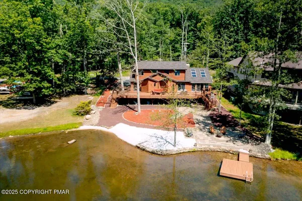 an aerial view of a house with a yard and trees