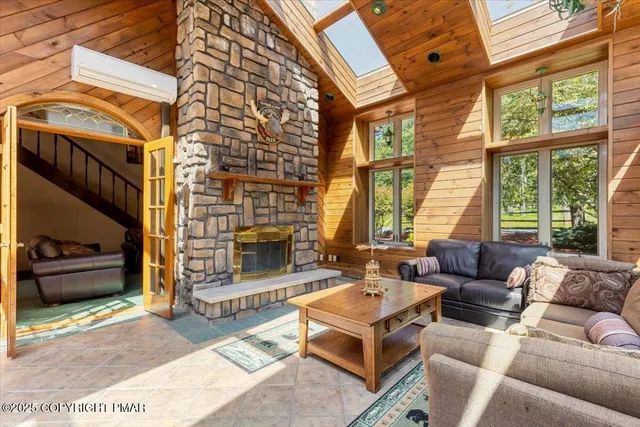 a view of a patio with table and chairs potted plants and large tree