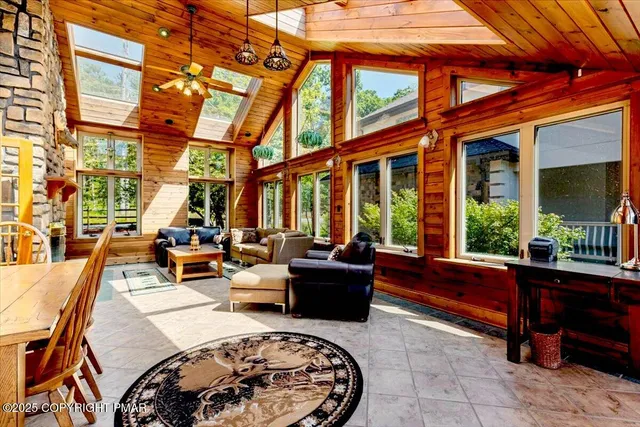 a view of a house with pool and chairs