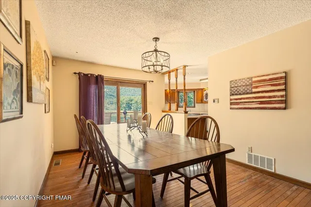 a view of a kitchen with stainless steel appliances granite countertop lots of white cabinets