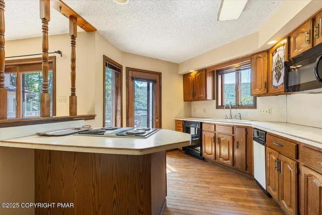 a view of a house with pool and chairs